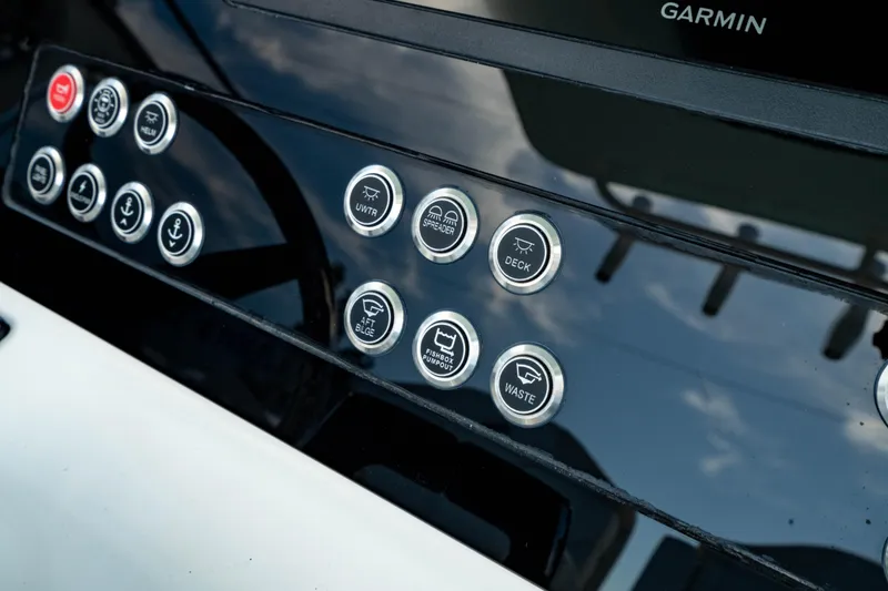 Slide: The Image of Control panel of 2025 Edgewater 262CC boat with labeled buttons and Garmin display. - 30