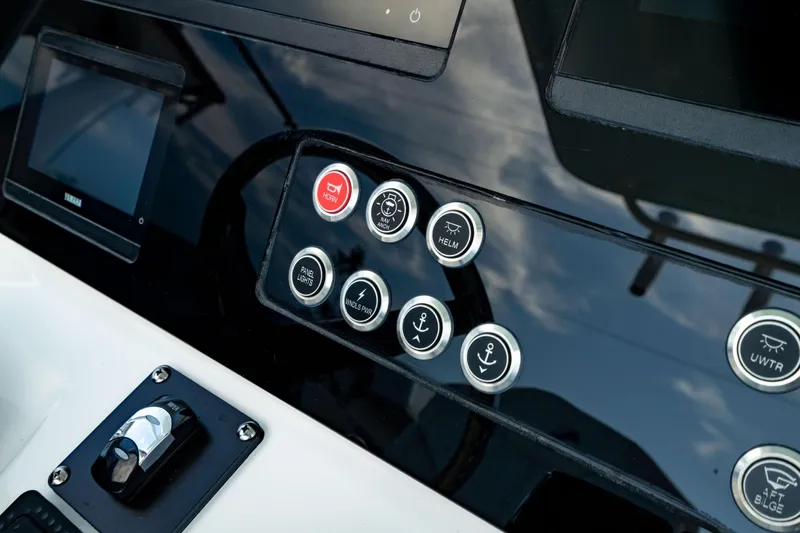 Slide: The Image of Control panel of 2025 Edgewater 262CC boat with various buttons and switches. - 31