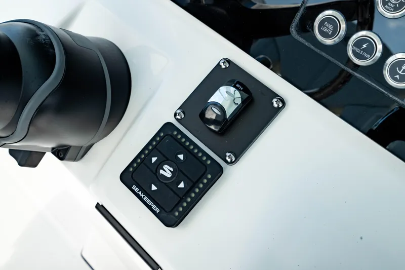 Slide: The Image of Control panel of 2025 Edgewater 262CC boat with joystick and buttons. - 32