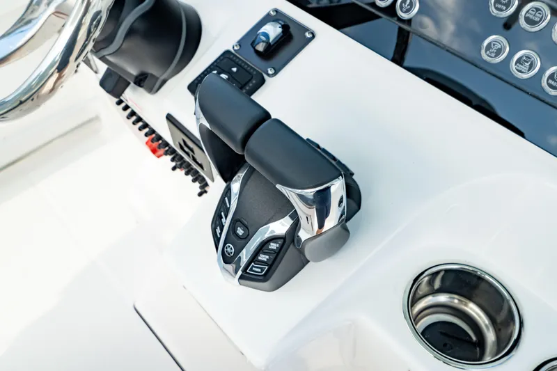 Slide: The Image of Throttle controls on a 2025 Edgewater 262CC boat dashboard, featuring modern design and functionality. - 33