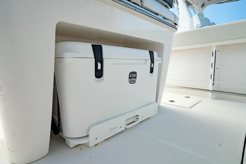 Slide: The Image of Edgewater 262CC 2025 boat interior with a secured cooler under the seat. - 36