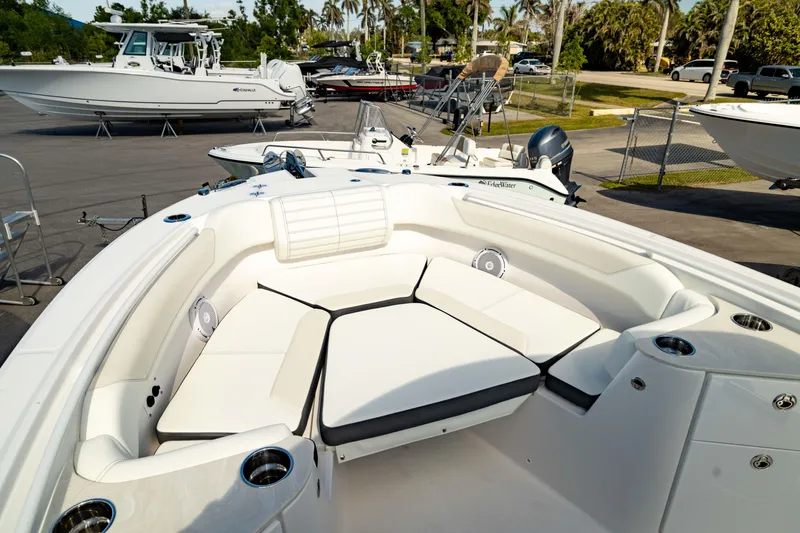 Slide: The Image of 2025 Edgewater 262CC boat with spacious white seating area and cup holders. - 4