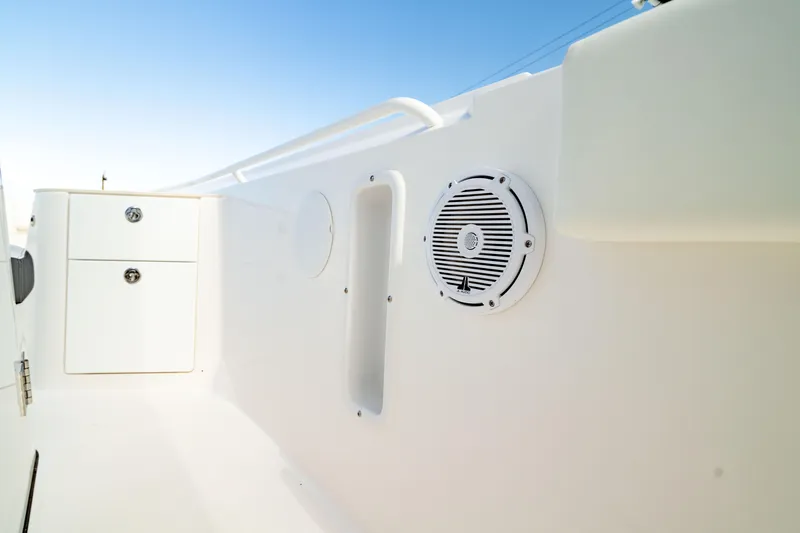 Slide: The Image of 2025 Edgewater 262CC boat interior with speaker and storage compartments. - 43