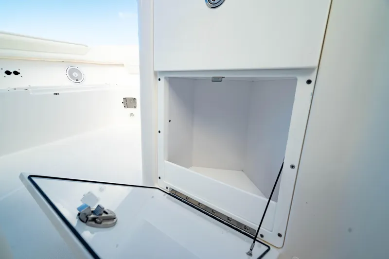 Slide: The Image of Open storage compartment on 2025 Edgewater 262CC boat, showcasing interior space. - 46