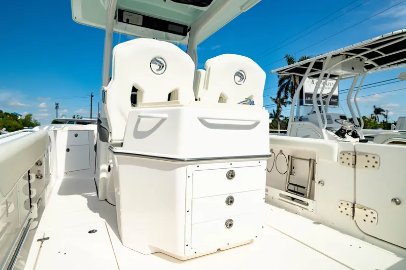 Slide: The Image of 2025 Edgewater 262CC boat interior with white seating and storage drawers. - 7
