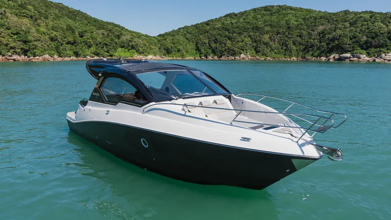 Slide: The Image of 2025 Granfort 366 GTS luxury boat on serene water with lush green hills. - 1