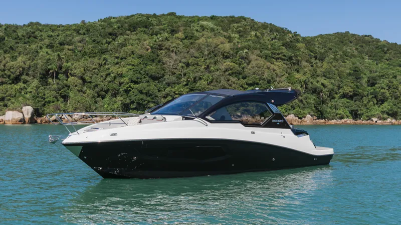 Slide: The Image of 2025 Granfort 366 GTS boat on serene water with lush green hills in the background. - 2