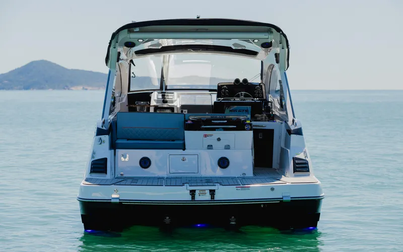 Slide: The Image of 2025 Granfort 366 GTS boat on calm sea, rear view with island in background. - 5