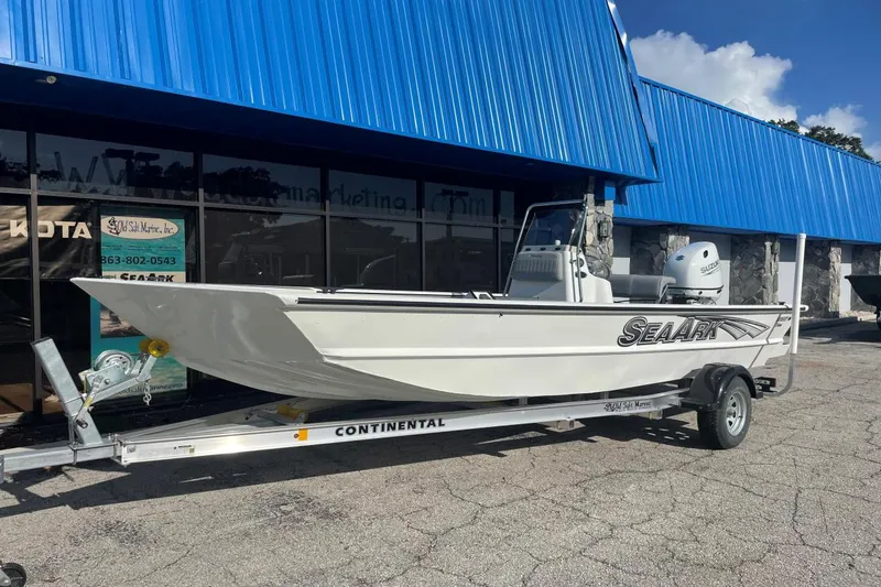 Slide: The Image of 2023 SeaArk 2072 FXTD CC boat on trailer outside a blue-roofed building. - 4