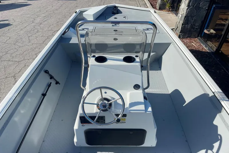 Slide: The Image of 2023 SeaArk 2072 FXTD CC boat interior with steering console and seating area. - 5