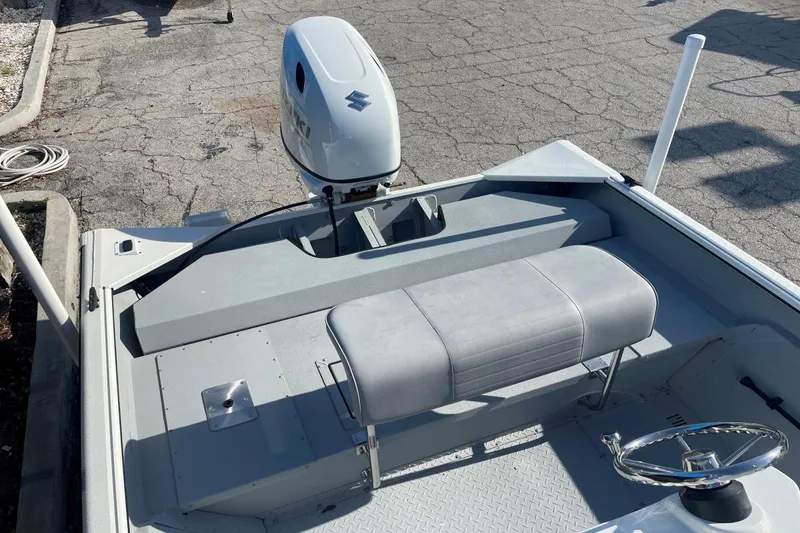 Slide: The Image of 2023 SeaArk 2072 FXTD CC boat with Suzuki outboard motor and gray seating. - 6