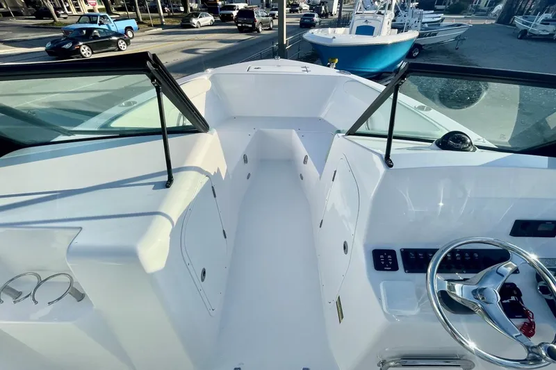 Slide: The Image of 2024 Aquasport 2200 DC boat interior with steering wheel and dashboard controls. - 6