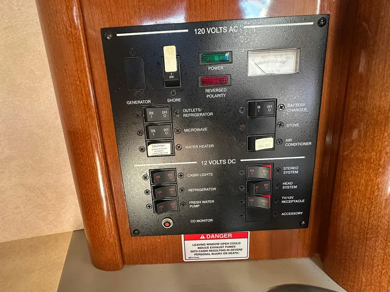 Slide: The Image of Electrical control panel on a 2010 Sea Ray 240 Sundancer boat. - 15