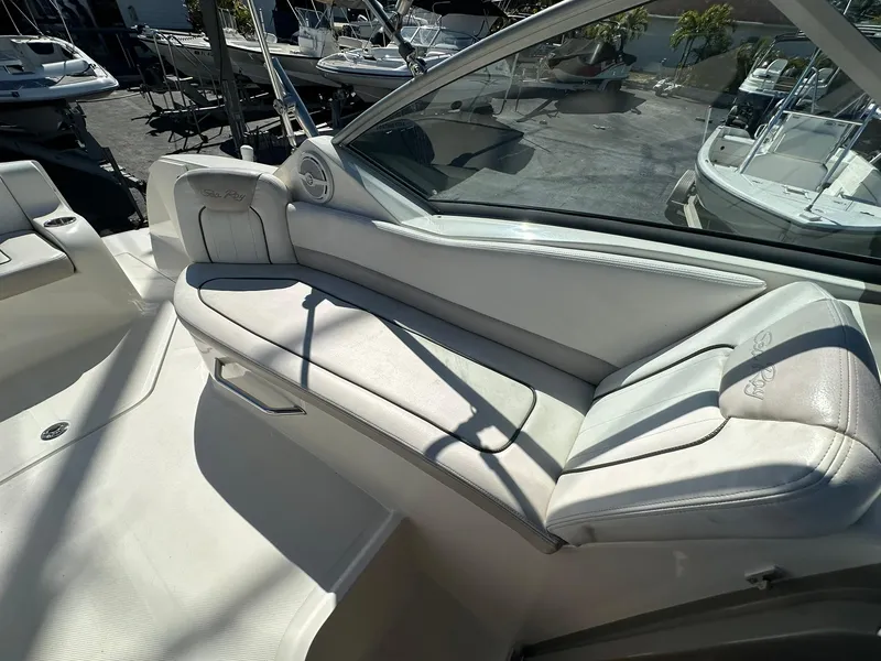 Slide: The Image of 2010 Sea Ray 240 Sundancer interior with white seating and sleek design. - 17