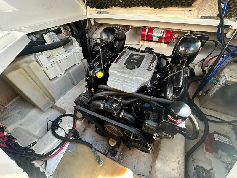Slide: The Image of Engine compartment of a 2010 Sea Ray 240 Sundancer boat, featuring a well-maintained motor. - 23