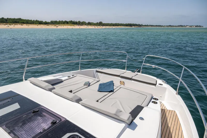 Slide: The Image of 2025 Jeanneau NC 1295 Coupe yacht with sunbathing deck on calm sea. - 12