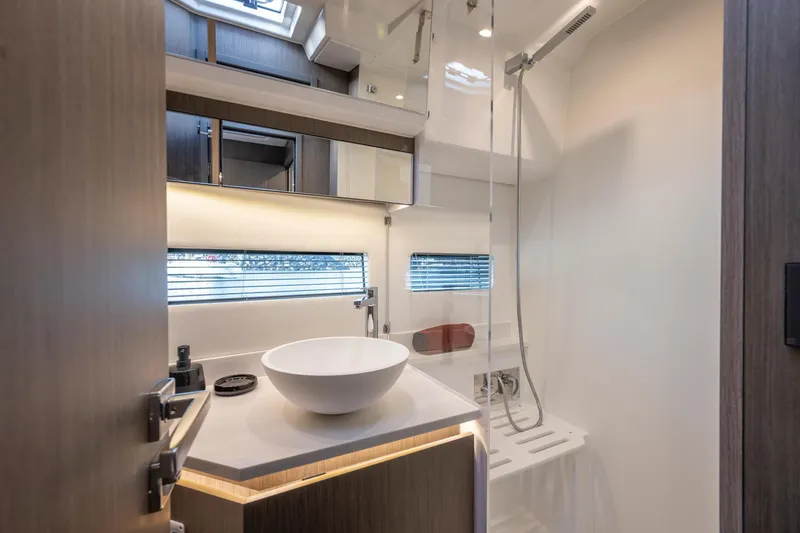 Slide: The Image of Modern bathroom in 2025 Jeanneau NC 1295 Coupe yacht with sleek fixtures and natural lighting. - 25