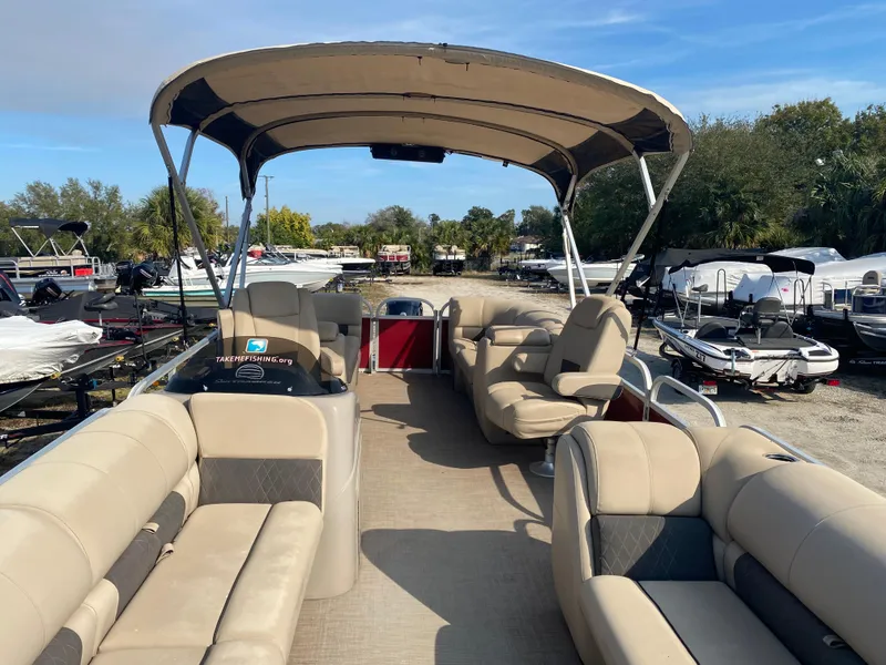 Slide: The Image of 2020 Sun Tracker Party Barge 24 DLX pontoon boat with beige seating and canopy. - 2