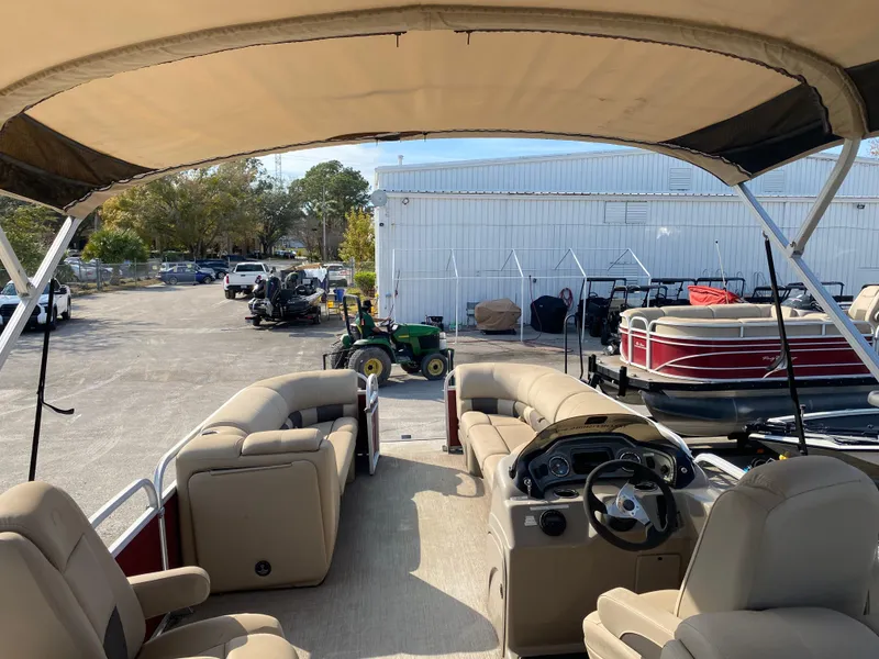 Slide: The Image of 2020 Sun Tracker Party Barge 24 DLX pontoon boat with beige seating and canopy. - 3