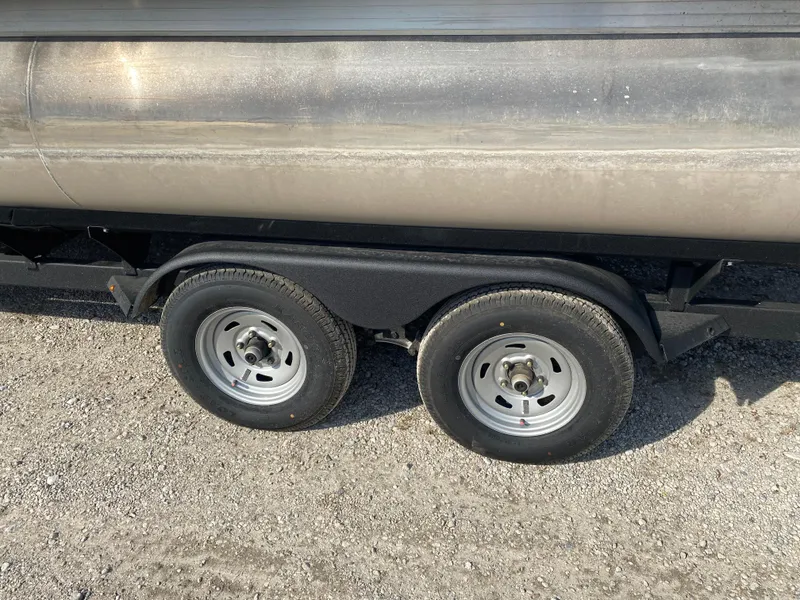Slide: The Image of Trailer wheels of 2020 Sun Tracker Party Barge 24 DLX on gravel surface. - 5
