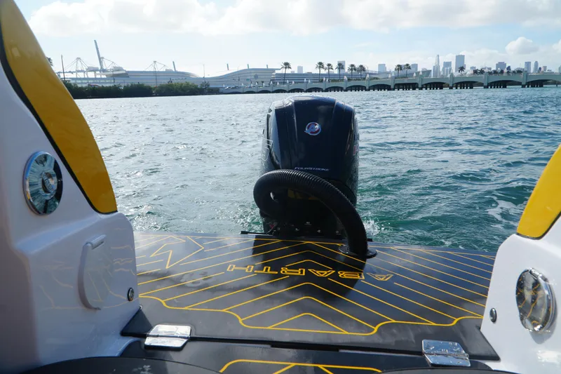 Slide: The Image of 2025 Car Off-shore Fiat 500 Abarth boat on water with city skyline in background. - 19