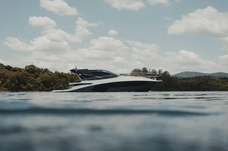 Slide: The Image of 2025 Granfort 420 Gran Coupe yacht on serene water with scenic background. - 1