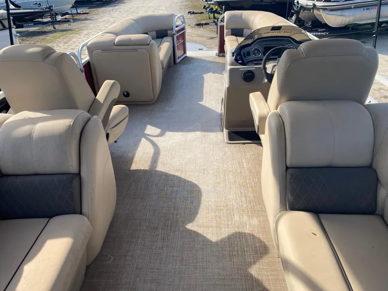 The Image of 2020 Sun Tracker Party Barge 24 DLX interior with beige seating and steering console. - 1