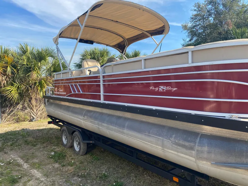 Slide: The Image of 2020 Sun Tracker Party Barge 24 DLX pontoon boat on trailer, parked outdoors. - 4