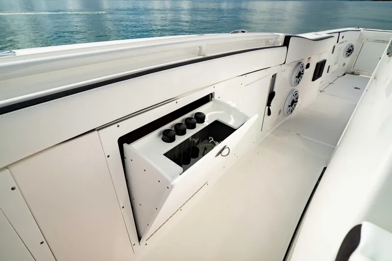 Slide: The Image of 2024 Crevalle 33 CTF boat interior with storage compartment and speakers. - 11