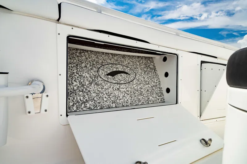 Slide: The Image of 2024 Crevalle 33 CTF boat storage compartment with open hatch, showcasing interior design. - 12