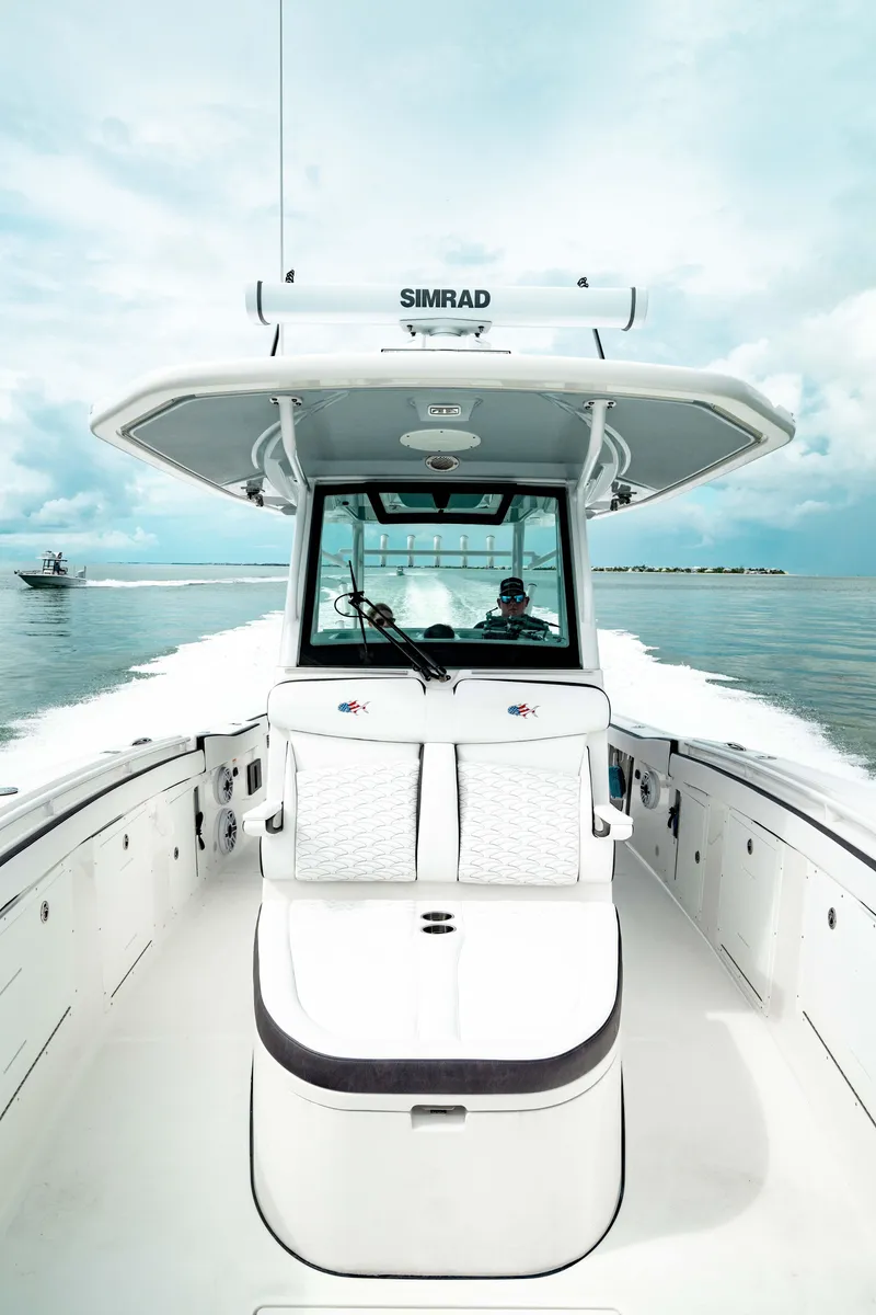 Slide: The Image of 2024 Crevalle 33 CTF boat cruising on open water, featuring advanced navigation equipment. - 13