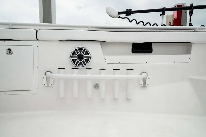 Slide: The Image of 2024 Crevalle 33 CTF boat interior with rod holders and speaker. - 15