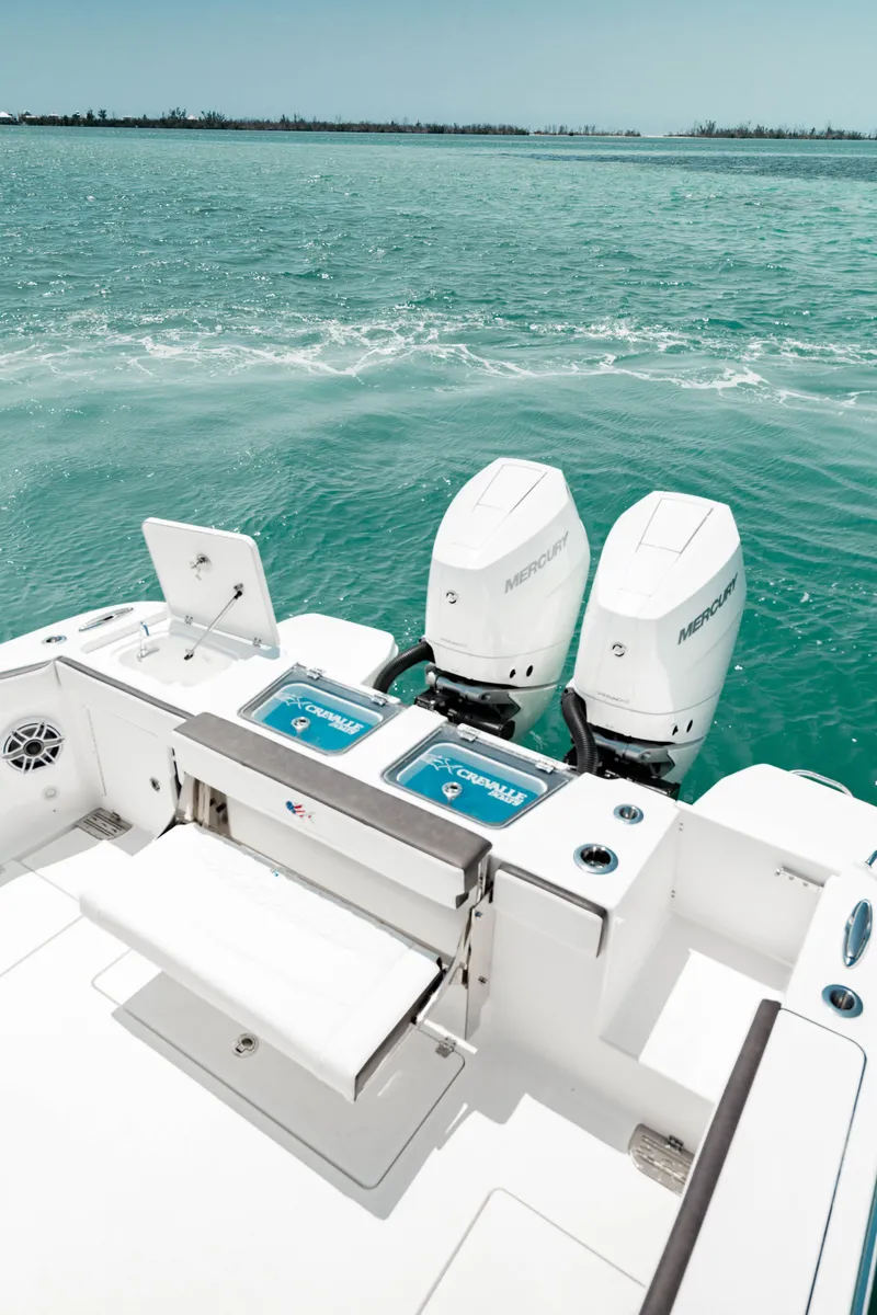 Slide: The Image of 2024 Crevalle 33 CTF boat with twin outboard motors on open water. - 16