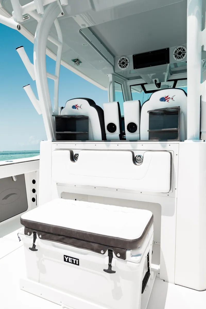Slide: The Image of 2024 Crevalle 33 CTF boat interior with seating and Yeti cooler. - 17