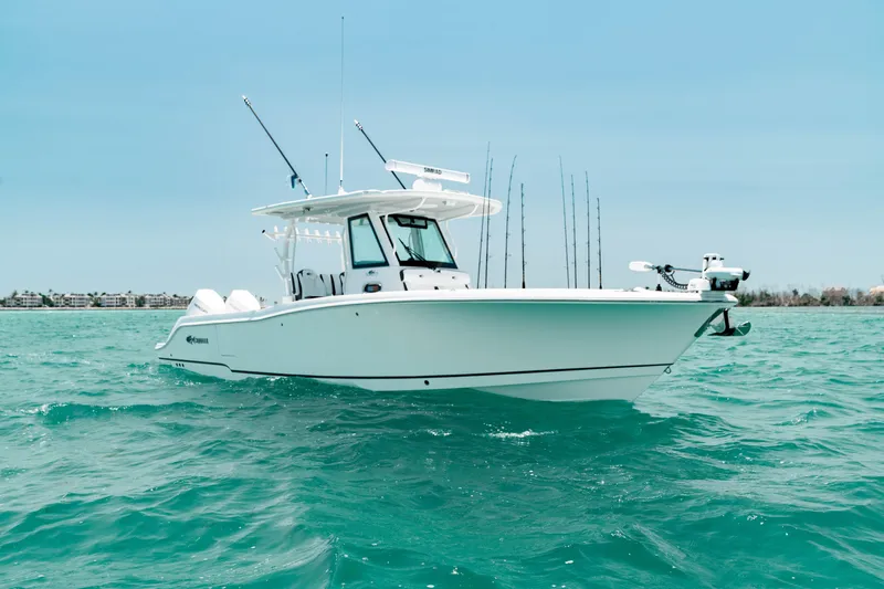 Slide: The Image of 2024 Crevalle 33 CTF boat on turquoise water, clear sky background. - 19