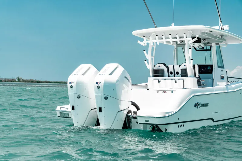 Slide: The Image of 2024 Crevalle 33 CTF boat with dual outboard engines on turquoise water. - 4