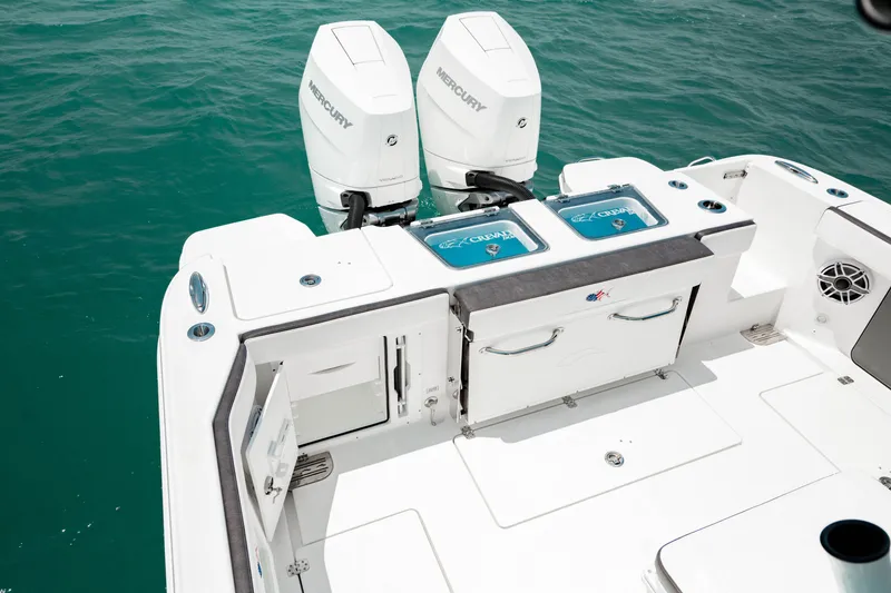 Slide: The Image of 2024 Crevalle 33 CTF boat with dual Mercury engines on turquoise water. - 5