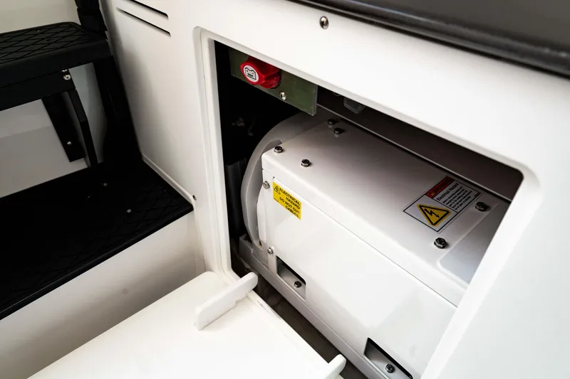 Slide: The Image of 2024 Crevalle 33 CTF boat interior compartment with equipment and safety labels. - 6