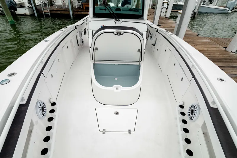 Slide: The Image of 2024 Crevalle 33 CTF boat interior with open storage compartment, docked at marina. - 7