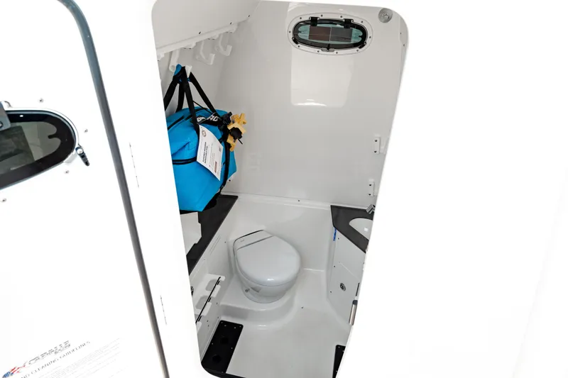 Slide: The Image of 2024 Crevalle 33 CTF boat interior with compact bathroom and storage. - 8