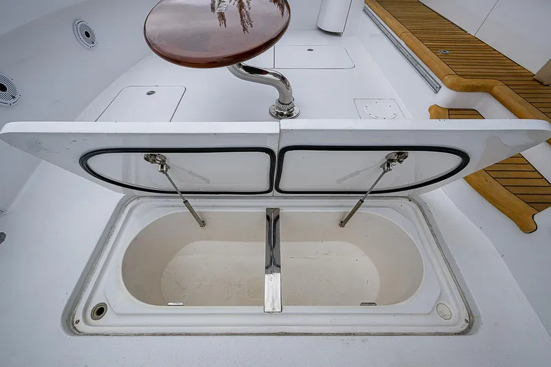 Slide: The Image of Open storage compartment on 2008 Hatteras 60 GT yacht deck, featuring wooden accents. - 15