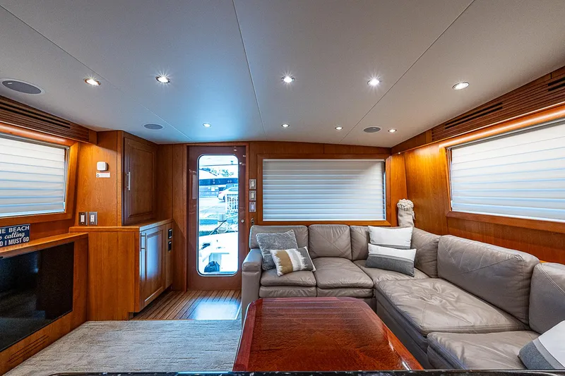 Slide: The Image of Luxurious interior of 2008 Hatteras 60 GT yacht with plush seating and wood accents. - 16