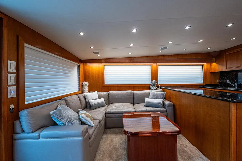 Slide: The Image of Luxurious interior of 2008 Hatteras 60 GT yacht with plush seating and elegant wood finishes. - 17