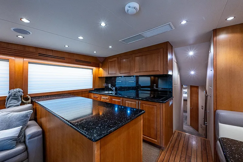 Slide: The Image of Luxurious interior of 2008 Hatteras 60 GT yacht with modern kitchen and wood finishes. - 19