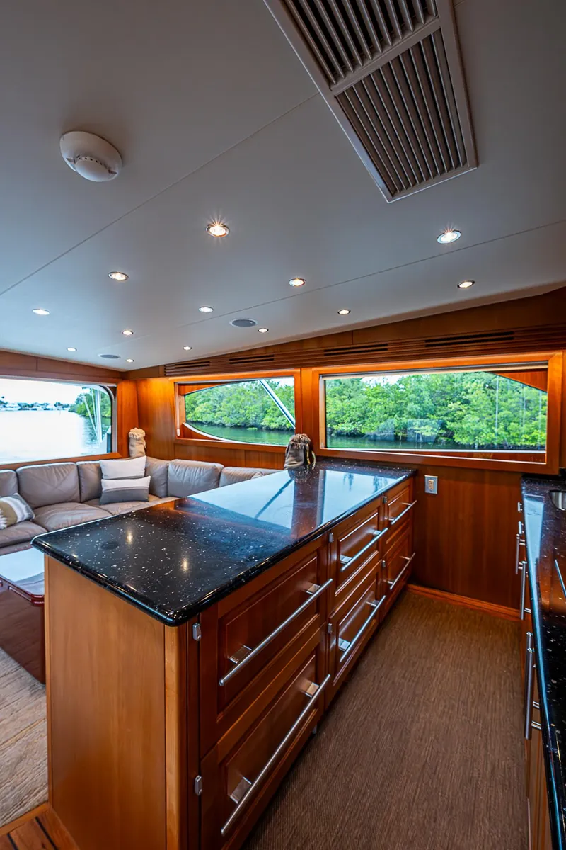 Slide: The Image of Luxurious interior of 2008 Hatteras 60 GT yacht with elegant wood finishes and spacious seating. - 23