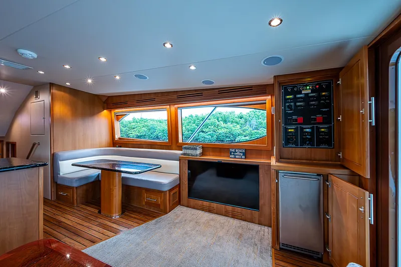 Slide: The Image of Luxurious interior of 2008 Hatteras 60 GT yacht with wood finishes and seating area. - 24