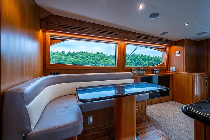 Slide: The Image of Luxurious interior of 2008 Hatteras 60 GT yacht with elegant wood finishes and seating. - 25