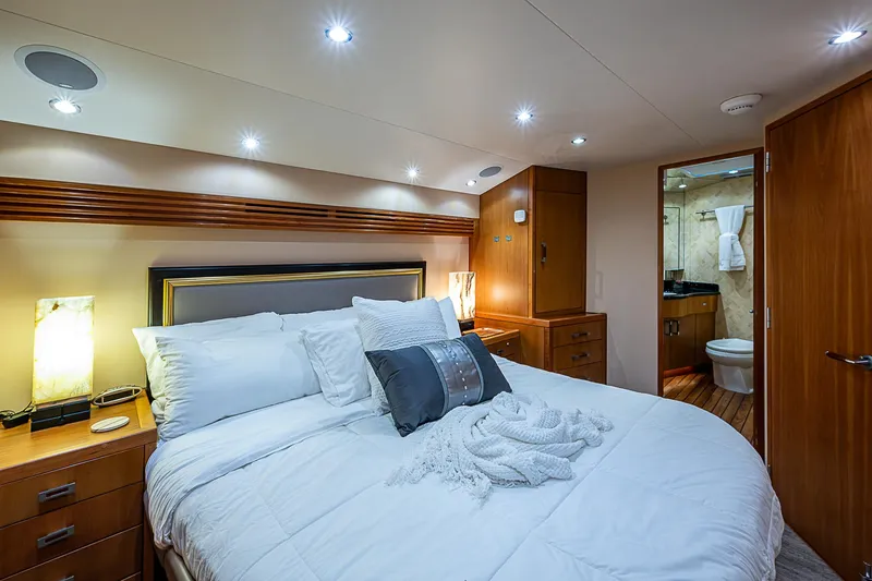 Slide: The Image of Luxurious bedroom interior of 2008 Hatteras 60 GT yacht with modern lighting and elegant decor. - 26
