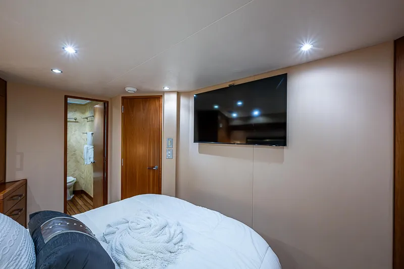 Slide: The Image of Luxurious bedroom interior of 2008 Hatteras 60 GT yacht with TV and ensuite bathroom. - 27