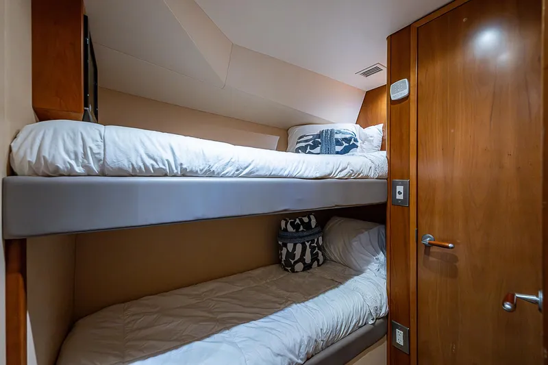 Slide: The Image of Bunk beds in 2008 Hatteras 60 GT yacht cabin with wooden interior. - 33